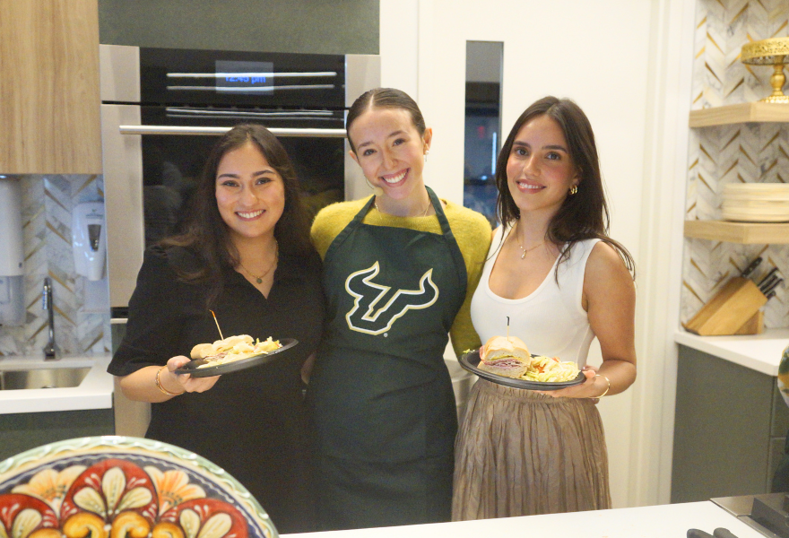 Reva Gandhi, Amelia Gonzmart, and Fabiana Requena share a cuban sandwich after the show.