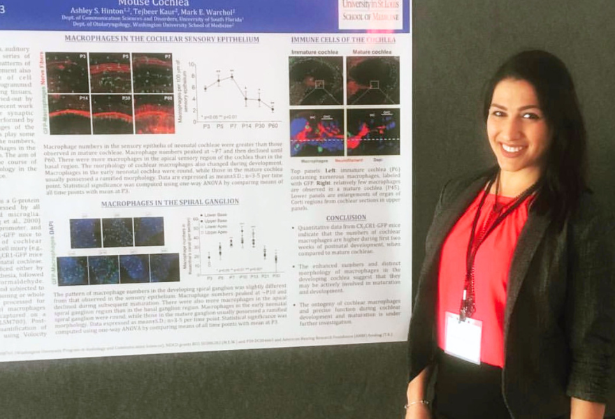 Ashley Hinton presents a research poster at an undergraduate research conference.