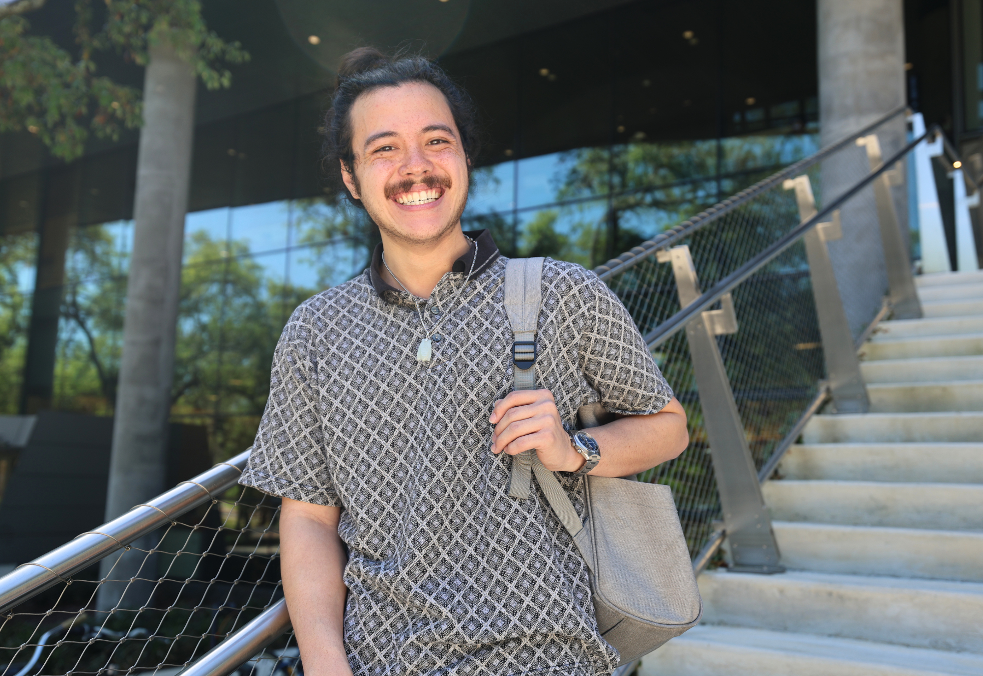 Jacob Ramirez on steps of Judy Genshaft Honors College building