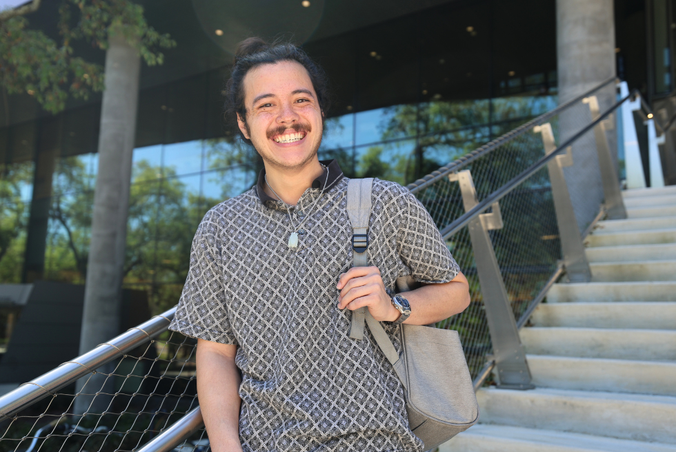 Jacob Ramirez on steps of Judy Genshaft Honors College building