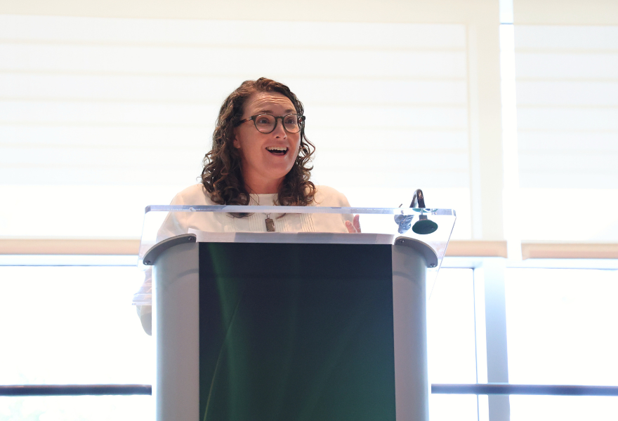 Assistant Director of the Tampa Bay Estuary Program Maya Burke encourages students at the St. Petersburg Honors College Convocation Ceremony.