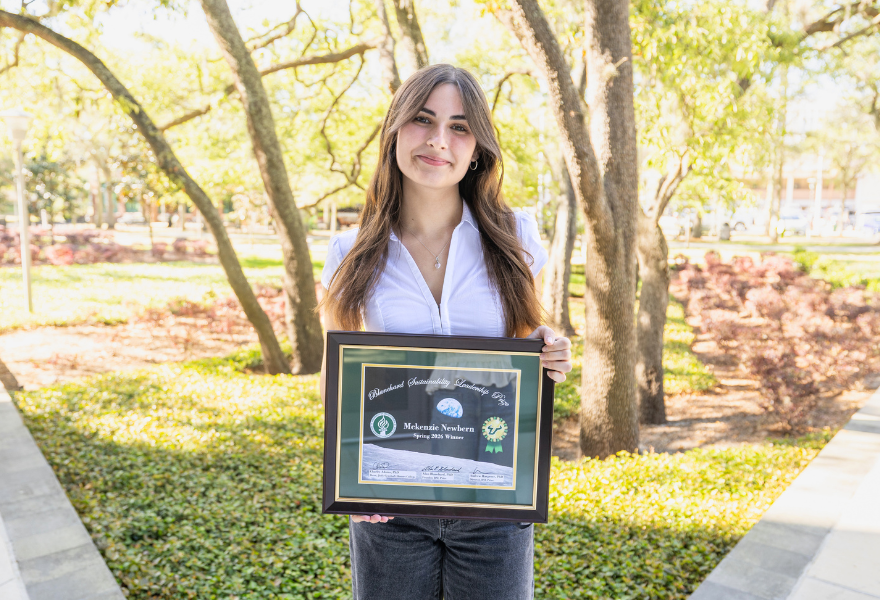 McKenzie Newbern outside with certificate