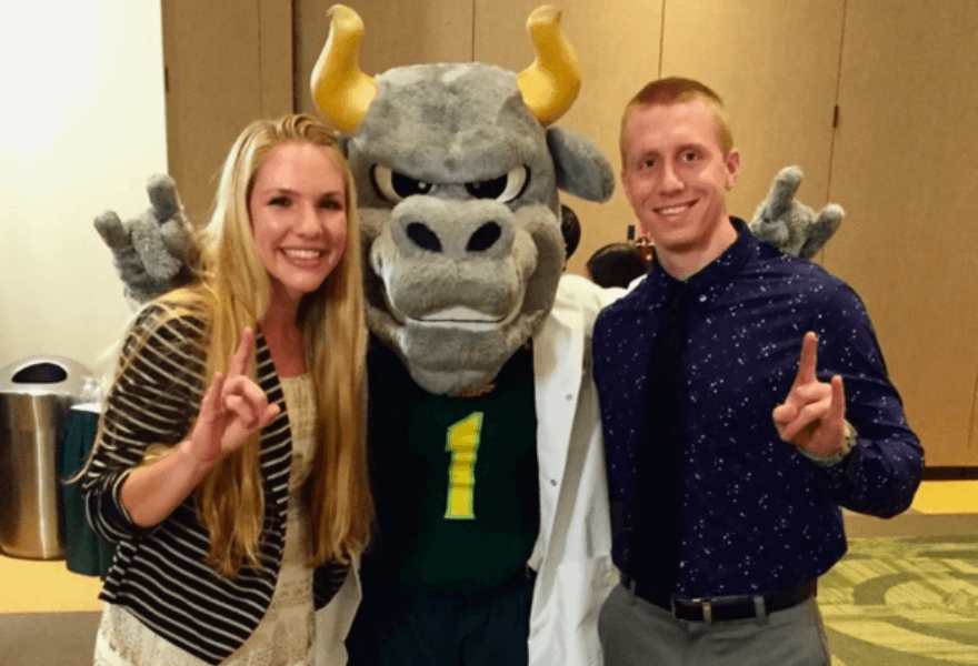 Savanah and Patrick Mullen pose with Rocky the Bull