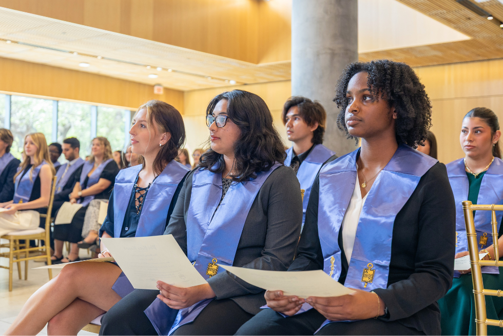 Phi Beta Kappa inductees sitting in Honors atrium with their stoles