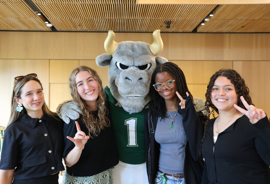 Students pose with Rocky D Bull in Zimmerman Family Atrium