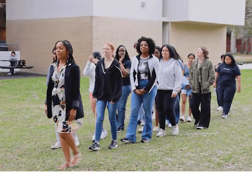 Ulluminair Salim leads her class through the grass on USF campus