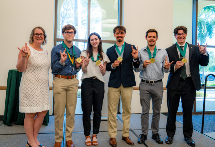 Dr. Lanier and USF Sarasota-Manatee Honors graduates pose with their Honors medallions.