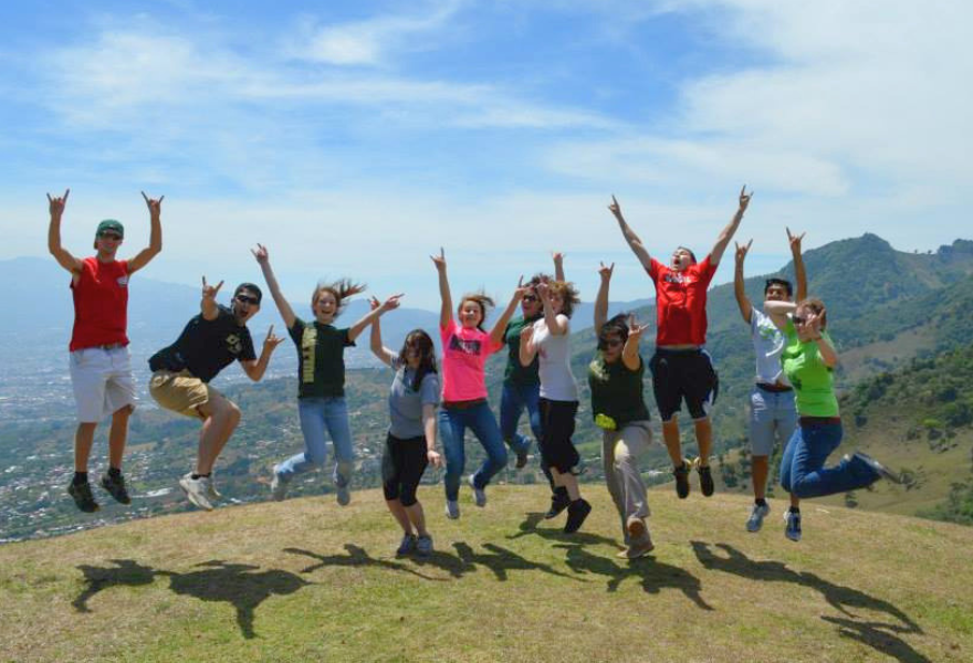 Sy-Woei and other Honors students jumping simultaneously on a hill