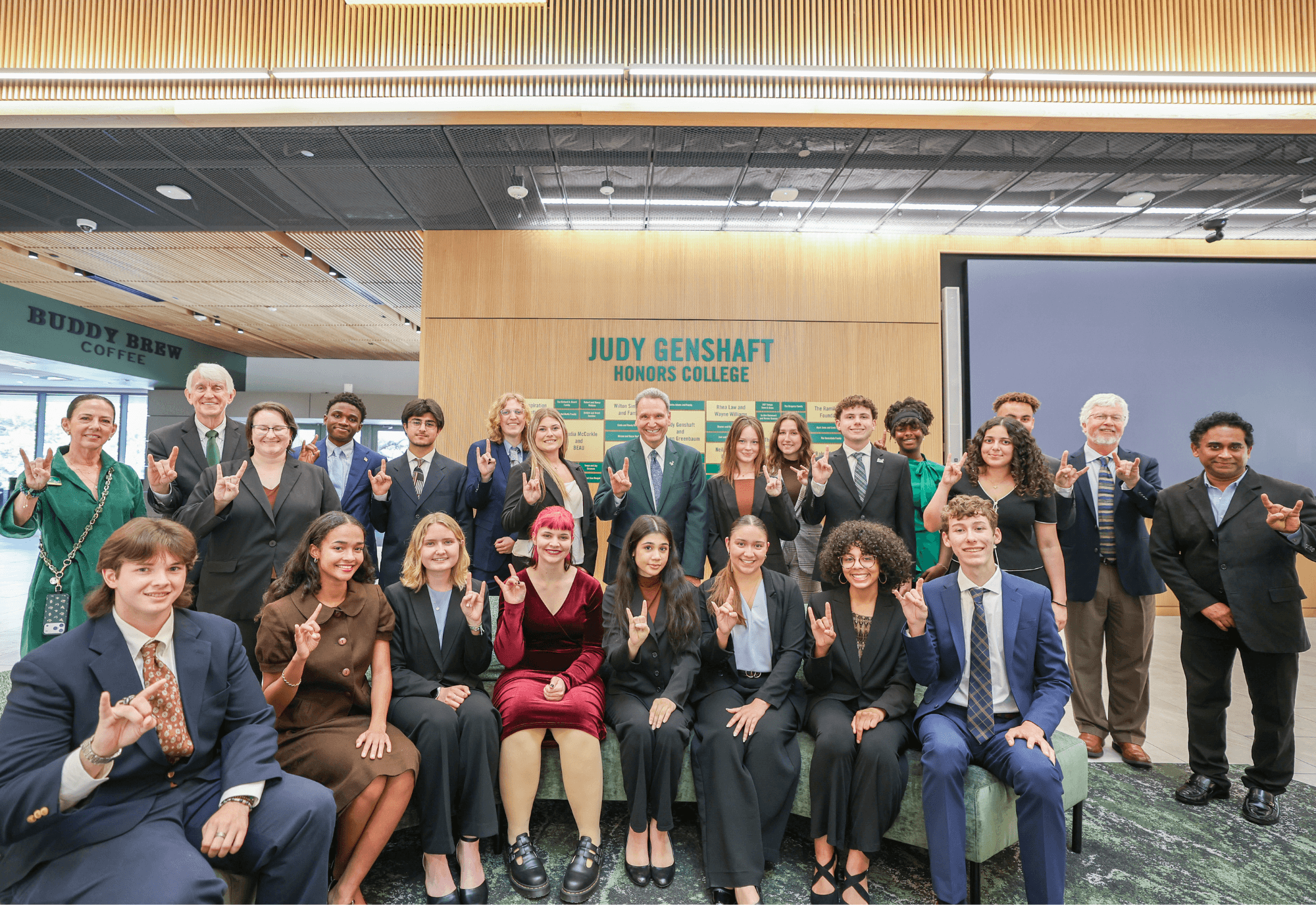 A large group of Wilcox Scholars pose with Dr. Ralph Wilcox, USF President Moez Limayem, and Honors staff in the Judy Genshaft Honors College atrium.