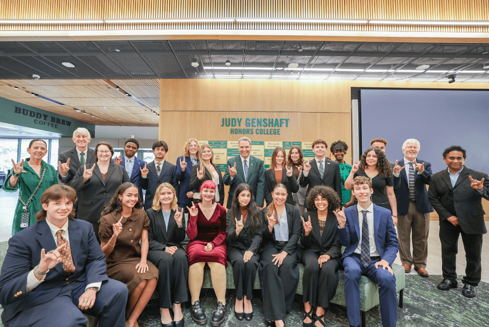 A large group of Wilcox Scholars pose with Dr. Ralph Wilcox, USF President Moez Limayem, and Honors staff in the Judy Genshaft Honors College atrium.