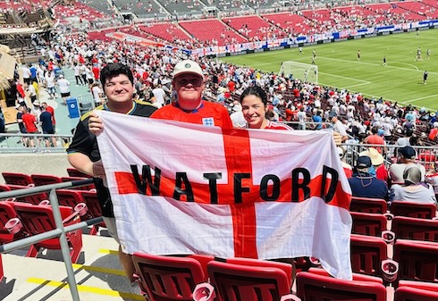 Three students holding English