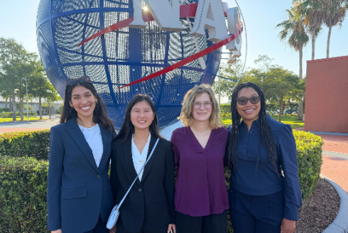 USF wound-healing team smiles in front of NASA monument.