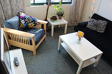 small living room area with a couch, two chairs and a coffee table