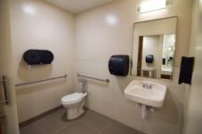 traditional dorm style bathroom with sink and toilet