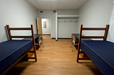 another angle of two beds and two desks across from each other