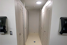 Bathroom Hallway with closed stall doors