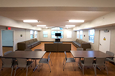 Common area with two tables with chairs and big couches