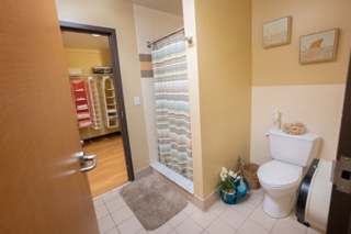 Jack and Jill style bathroom with shower and toilet
