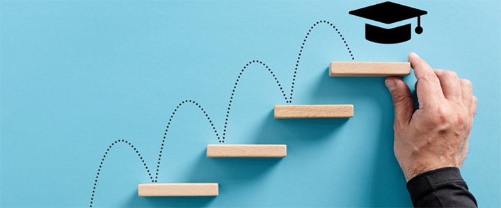 4 shelves on a blue wall with a dotted lining going up each shelve with the top shelve having a graduation cap with a hand
