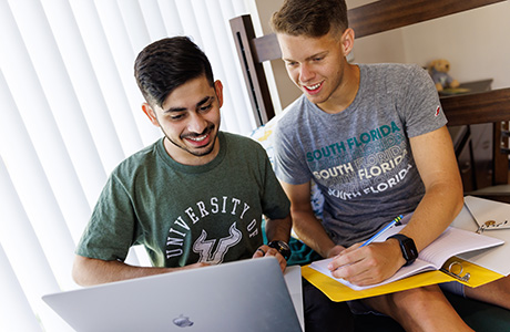 two students sitting on computer