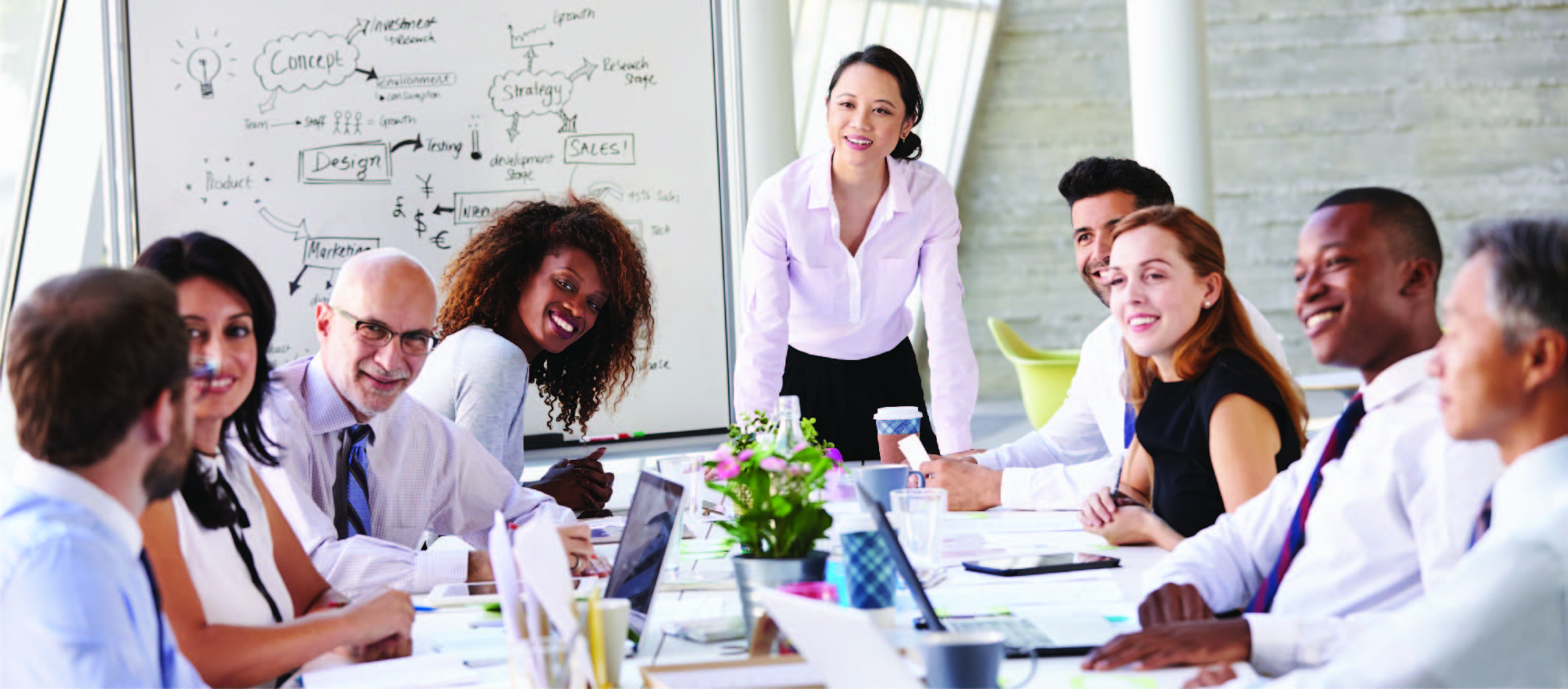 professional employees engaged in a corporate meeting around a conference table