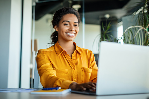 a woman on a laptop smiling