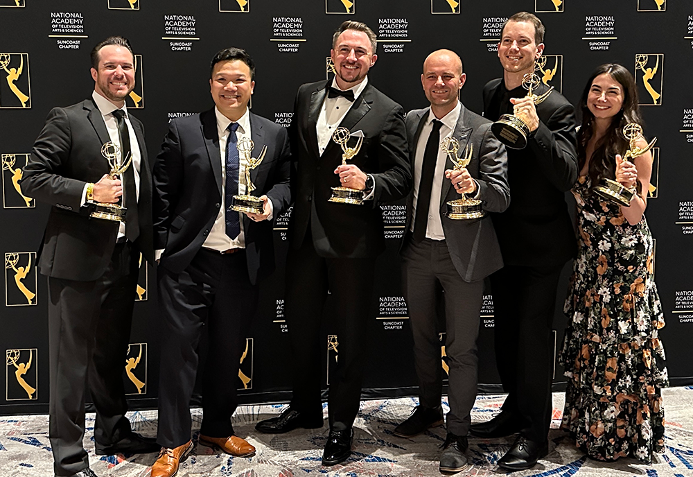 6 InEd Studios employees pose with emmys. 