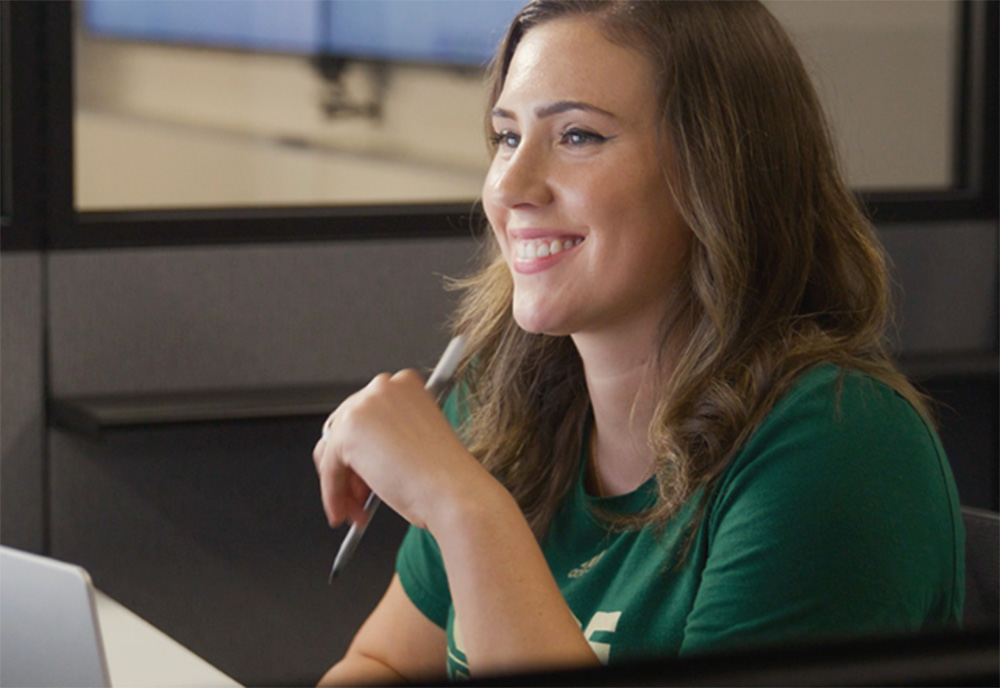 Haley smiles looking at computer