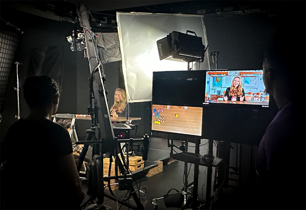 Professor Sarah van Ingen Lauer stands at light board ready to film