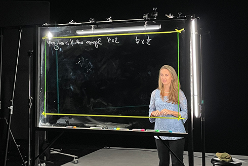 Teacher standing at light board