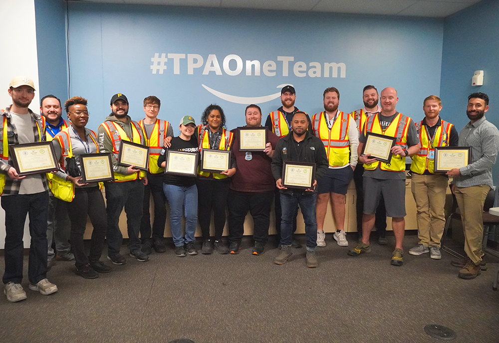 Group of Lean Six Sigma graduates pose with their new certificates. 