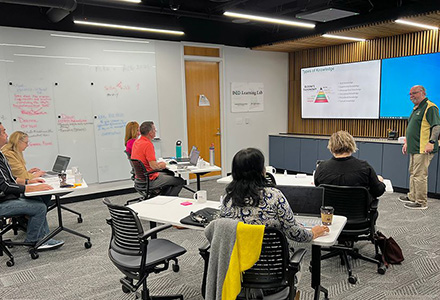 a group of faculty sit in the learning lab