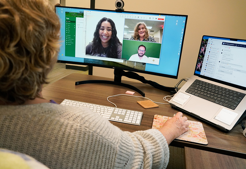 a live support specialist sits on a video call with 3 other people. 