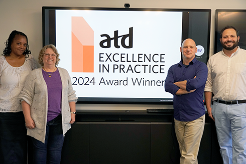 digital learning faculty training and support members pose with award winner sign