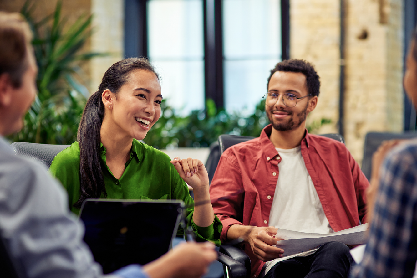 Group of employees talking together at work.
