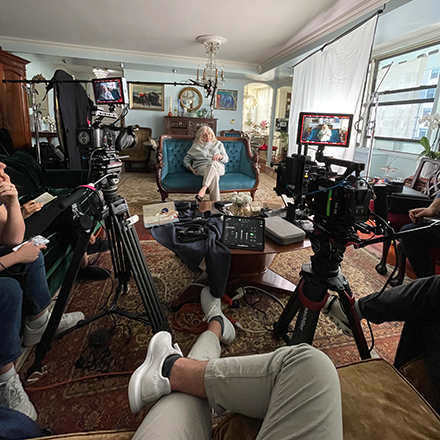 Ildiko Trien sits in front of camera and camera crew while filming her interview