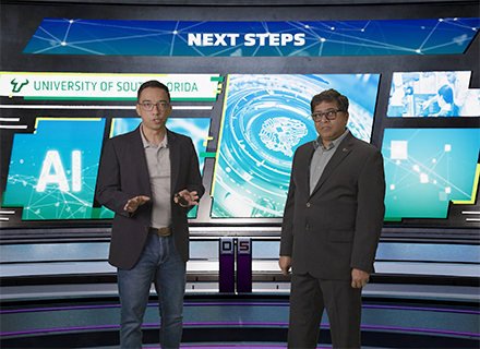 dr sudeep Sarkar and dr john licato stand on set while filming for their AI course