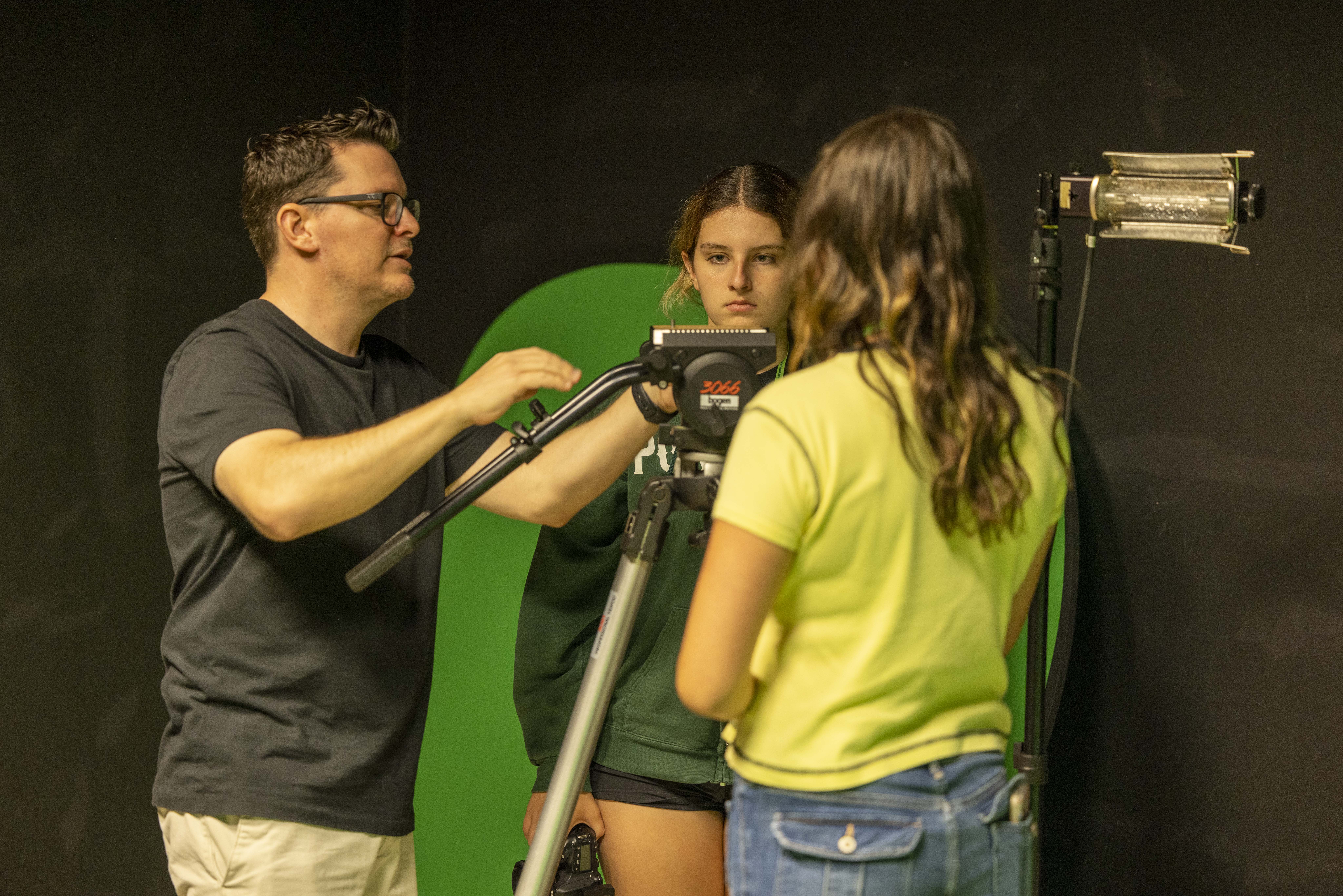 USF Professor helping campers with their filmmaking process.