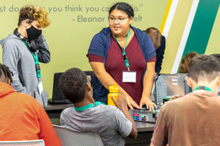A community volunteer shares her experiences and expertise at a summer technology camp.