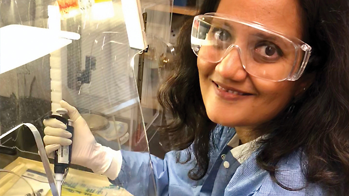Picture of Aparna Tatavarthy in a lab wearing goggles