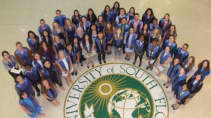 Aerial picture of the Phi Beta Kappa members standing around the USF seal