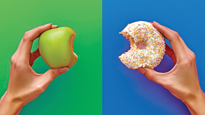 2 hands holding an apple in one and doughnut in another