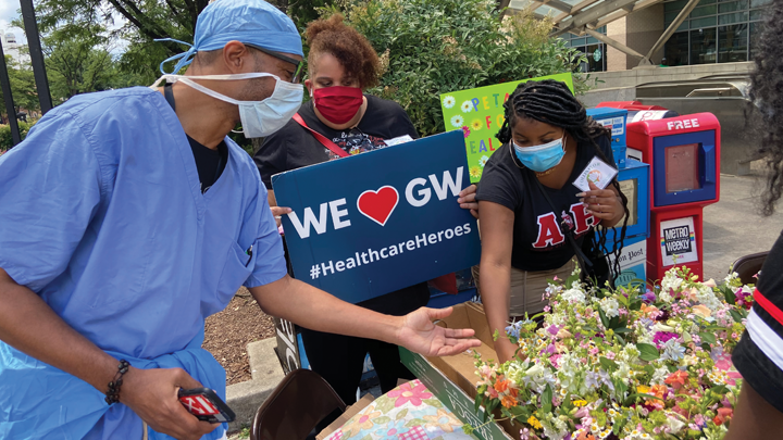 Agroup of people at a flower-sharing event at George Washington University Hospital