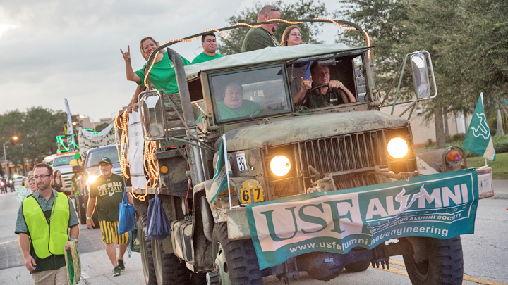 USF Alumni in back of military truck in a parade