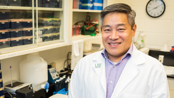 USF virologist Michael Teng smiling in his lab