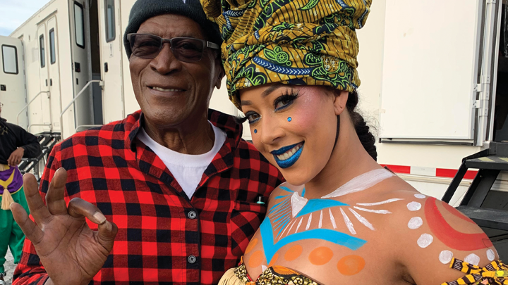Kyaien Conner with actor John Amos on the set of “Coming 2 America.”
