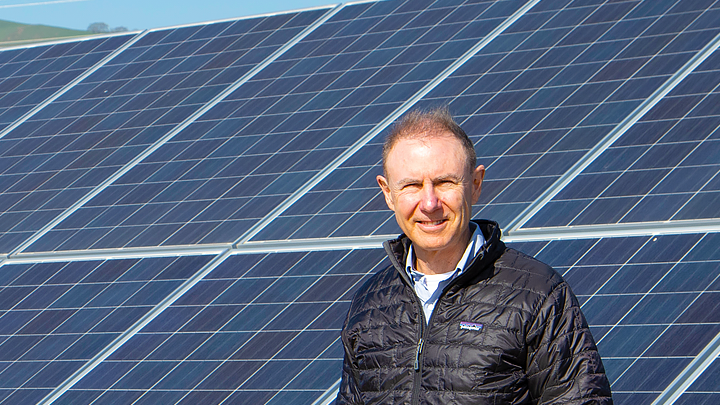 Jamie Owen ’84 poses in front of the solar array at the Clorox Fairfield manufacturing plant in California.