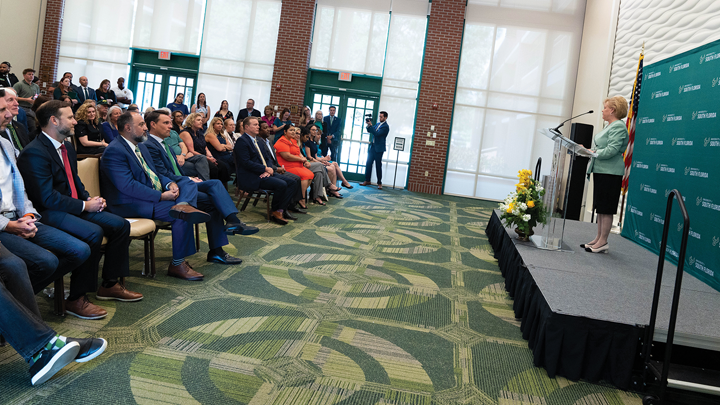 President Rhea Law speaks to celebrating group in Traditions Hall, Alumni Center.