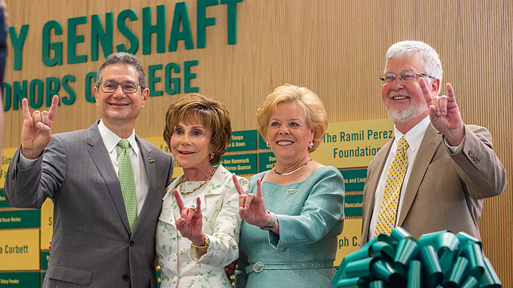 Steven Greenbaum, President Emerita Judy Genshaft, President Rhea Law and Honors College Dean Charles Adams stand side-by-side, smiling and making the Bull Horn U gesture.