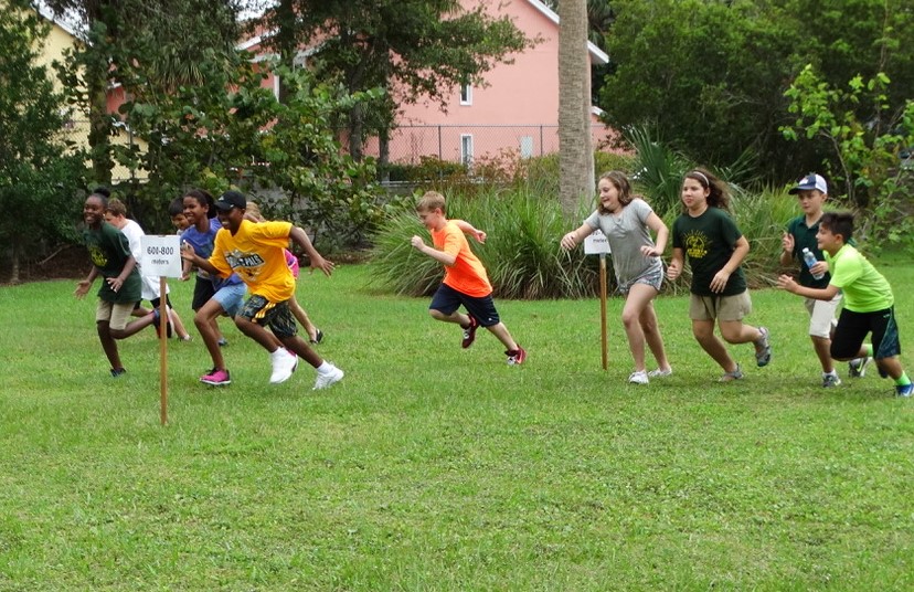 Elementary scholars running through the water column.